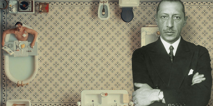 Collage showing Igor Stravinsky in a suit in front of a symmetric bathroom set from a Wes Anderson film – top-down view of a man in the tub.